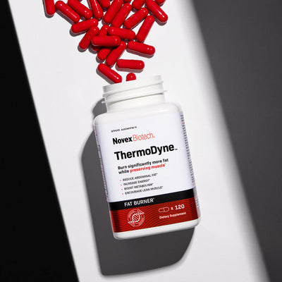 A bottle of Thermodyne with red capsules artistically spilling out